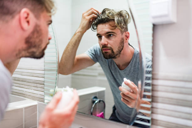 istock Young man stylizing his hair in the bathroom 1224547007