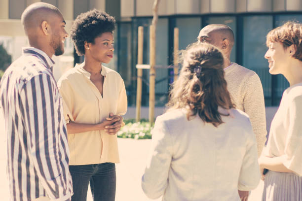 istock Smiling young people talking on street 1224548305