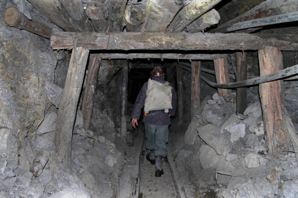 A miner walks through a dangerously unstable shaft of a mine in Cerro Rico. stock photo