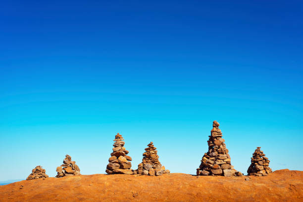istock Six Man Made Stone Trail Marker Cairns in a Pyramid Formation 1224551889