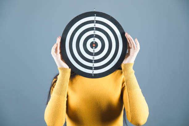 istock Woman covers face with target on grey background 1224554707