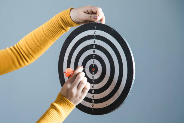 istock woman hand holding target on gray background 1224554708