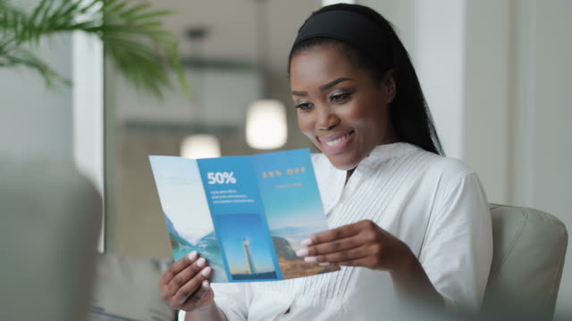 Black Woman Reading Travel Flyer And Planning Holidays Trip
