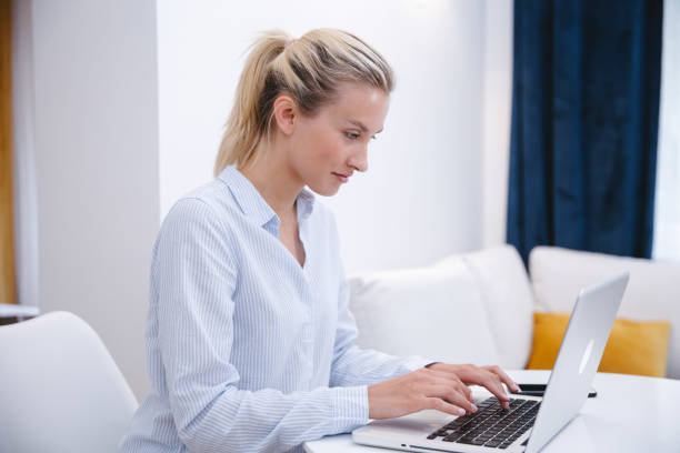 istock Young blonde woman working with computer at home. 1224556055