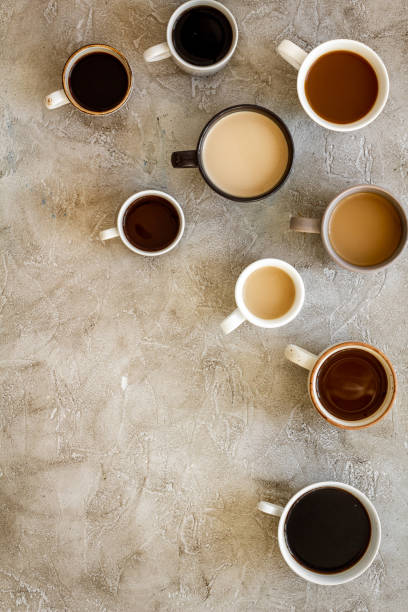 istock Different cups of coffee on beige table top-down space for text 1224556220