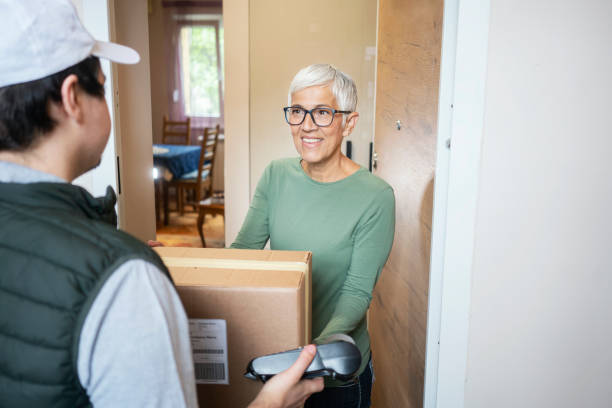 istock Senior woman received package from courier 1224556793