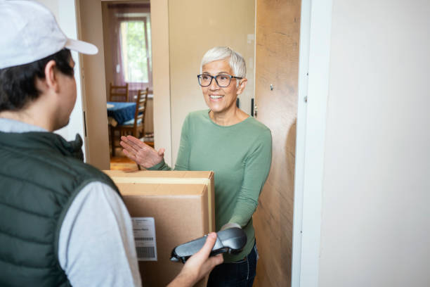 istock Senior woman received package from courier 1224556794