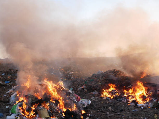 istock puffs of smoke from the trash. burning garbage. concern for the environment. environmental pollution 1224556802