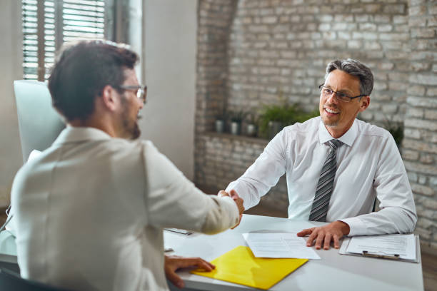 istock Happy manager shaking hands with a candidate during job interview. 1224556879