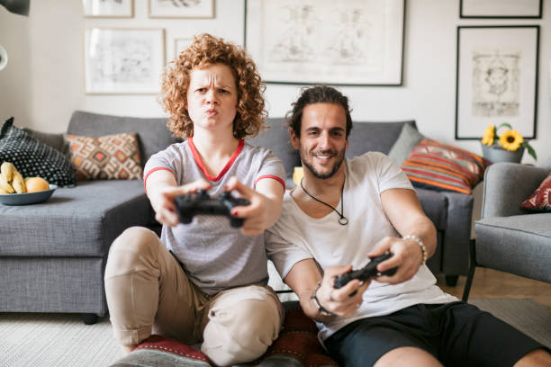 istock Front view of two housemates playing video games 1224558424
