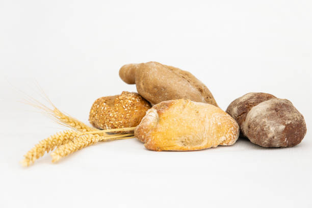 istock Many different delicious breads and three ears of wheat 1224559706
