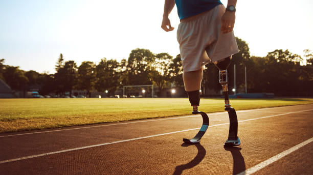 istock Athletic Disabled Fit Man with Prosthetic Running Blades is Posing During Preparation Befor Training on an Outdoor Stadium on a Sunny Afternoon. Amputee Runner Standing on a Track. Motivational Sports Shot. 1224561632