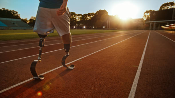 istock Athletic Disabled Fit Man with Prosthetic Running Blades is Walking During a Training on an Outdoor Stadium on a Sunny Afternoon. Amputee Runner Preparing for a Run. Motivational Sports Shot. 1224562114