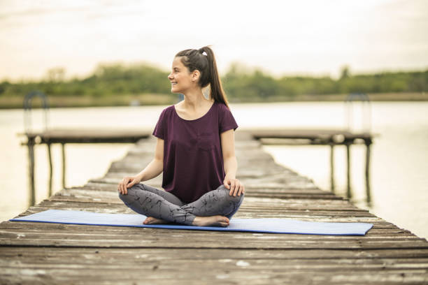 istock Young woman in Half Lotus pose 1224562442