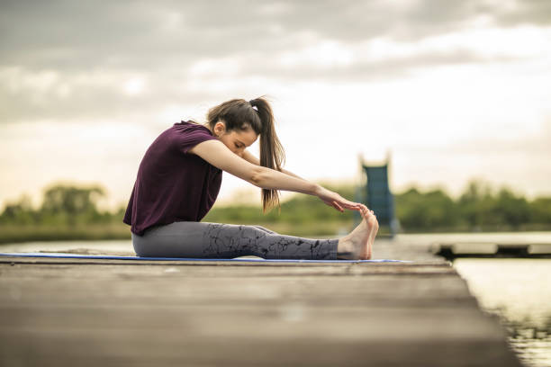 istock Yoga exercises on lake pier 1224563520