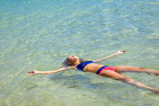 istock Girl floating in the sea 1224563638