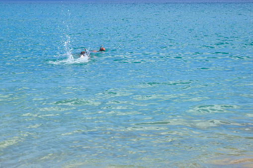 Father and daughter snorkeling at the sea in Porto Santo island