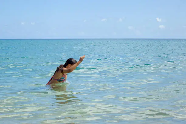 Teen diving in the sea at Porto Santo