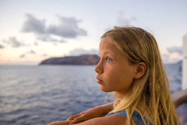 Ten year old blond girl looking at the sea