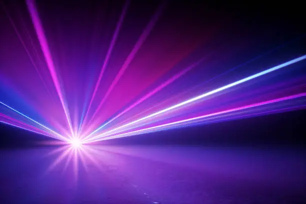 Photo of 3d render, stage lighting, shining star rays with lens flare effect, glowing neon light, over black background. Abstract image of disco lights