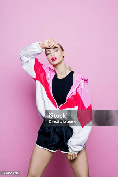 Fashion Portrait Of Beautiful Woman In Tracksuit Against Pink Background Stock Photo - Download Image Now