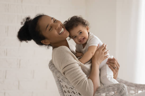 istock Happy biracial mom cuddle with cute little infant 1224568055