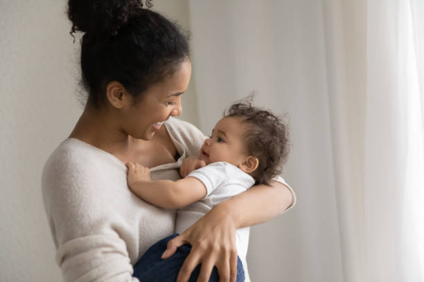 istock Caring african American mom lull small baby 1224568097