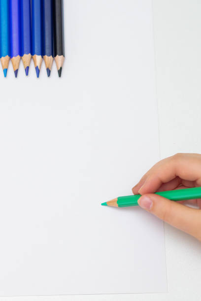 istock Kid is drawing on white blank paper. 1224570533
