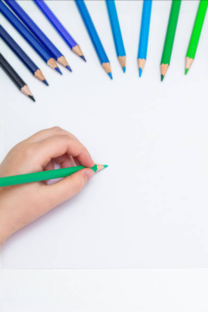 istock Kid is drawing on white blank paper. 1224570564