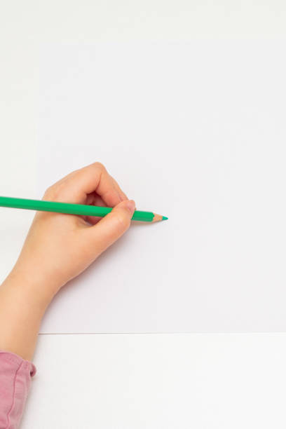 istock Kid is drawing on white blank paper. 1224570724