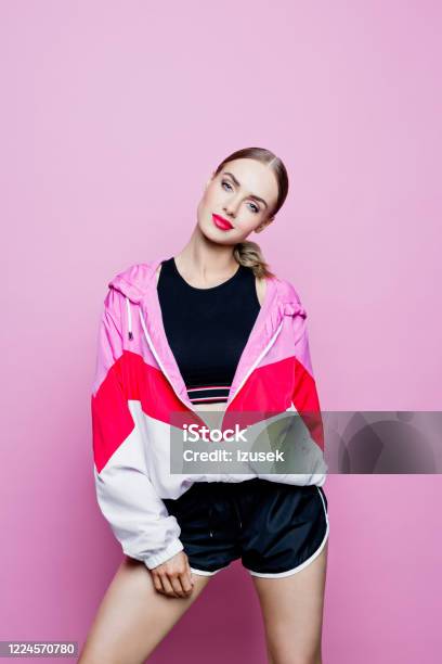 Sport Portrait Of Cheerful Woman In Tracksuit Against Pink Background Stock Photo - Download Image Now