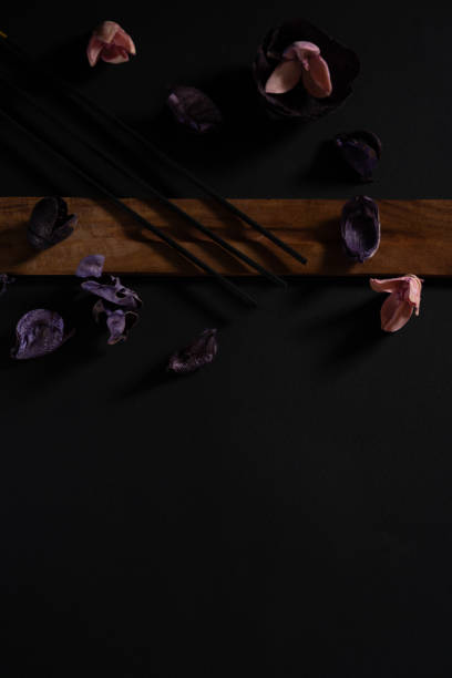 istock Eastern aromatherapy. Dry flowers and incense on a dark background 1224570981