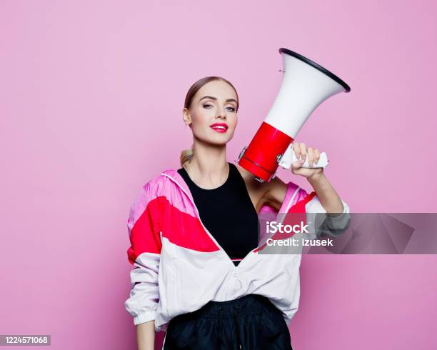 Sports Portrait Of Beautiful Woman In 80s Style Tracksuit Holding Megaphone Stock Photo - Download Image Now