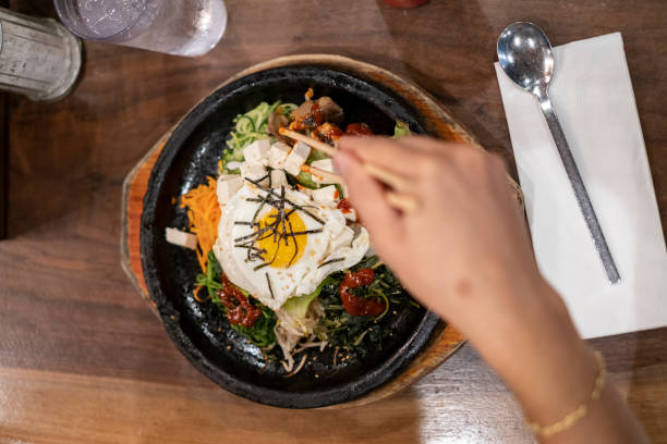 Person eating Korean bibimbap