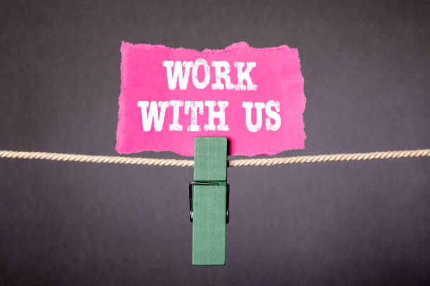 istock WORK WITH US Concept. Sheet of paper attached with peg 1224572612