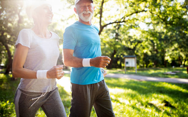 istock Senior couple jogging and running outdoors in nature 1224574404