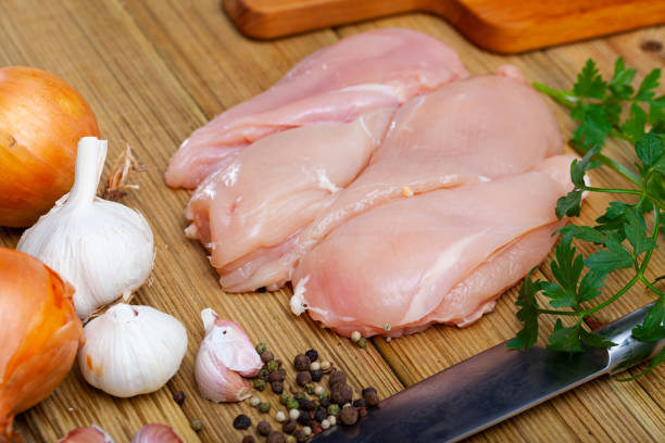 istock Raw chicken breast fillet on wooden surface, nobody 1224576362
