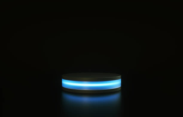 istock 3D cylinder pedestal with blue glow isolated on black background. 3d render illustration 1224576951