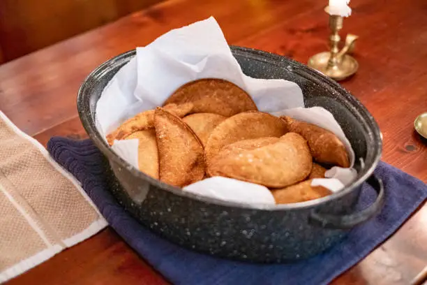 Fresh homemade deep fried Brazilian pastel.  Brazilian pasteis draining on paper towels.