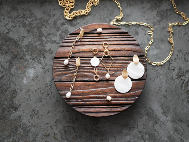 istock Gold earrings on a wooden background 1224578048