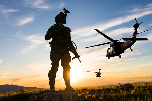 Silhouette of a combat helicopter in the sky, gazelle seen from underneath, air transportation