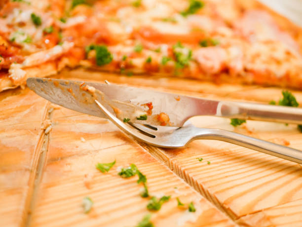 knife and fork on a background of pizza. side view