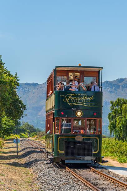 A tram arrive at Rickety Bridge Winery Railway Station, Franschhoek where Tourist take a Wine Tasting Tour stock photo
