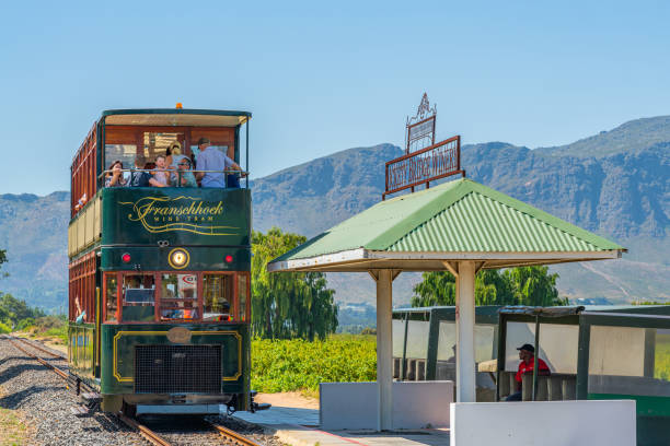 A Tram arrive at Rickety Bridge Winery Railway Station, Franschhoek where Tourist take a Wine Tasting Tour stock photo