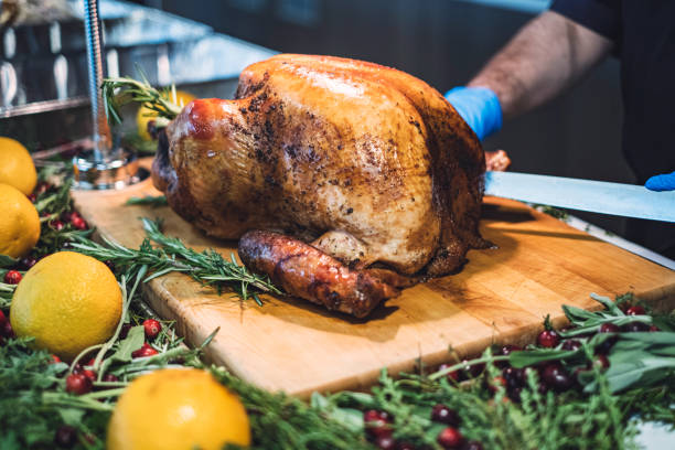 istock Chef carving roasted turkey for Thanksgiving 1224578970