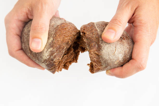 istock Tasty bun made of rye flour teared by hands 1224583122