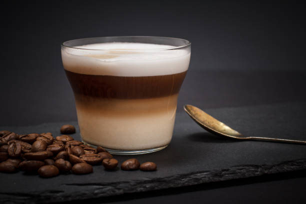istock Coffee cappuccino and coffee beans on black background 1224584083