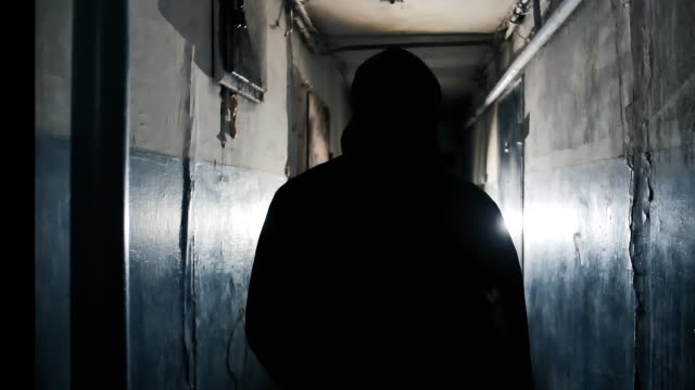 The Camera Follows Unrecognizable Man Going Along the Walkway in the Dark Dirty Shabby Apartment Building.