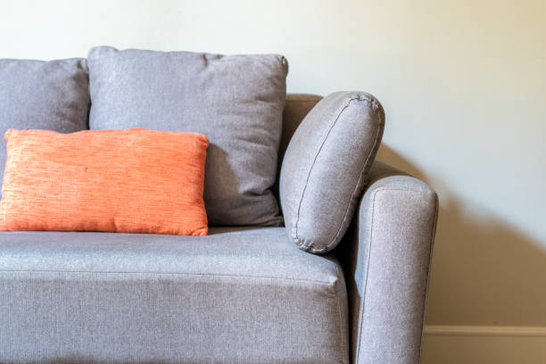 istock Elegant fabric grey sofa with styled cushions pillows in a classy living room 1224585906