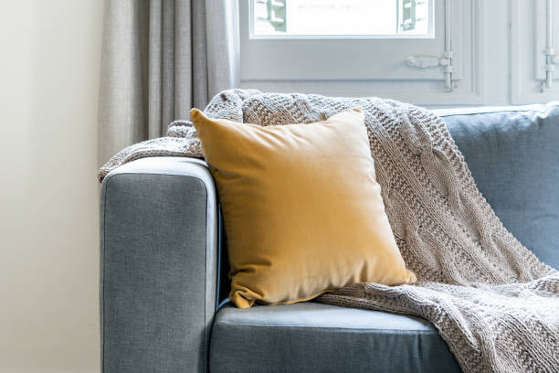 istock Elegant fabric grey sofa with styled cushions pillows in a classy living room 1224586074